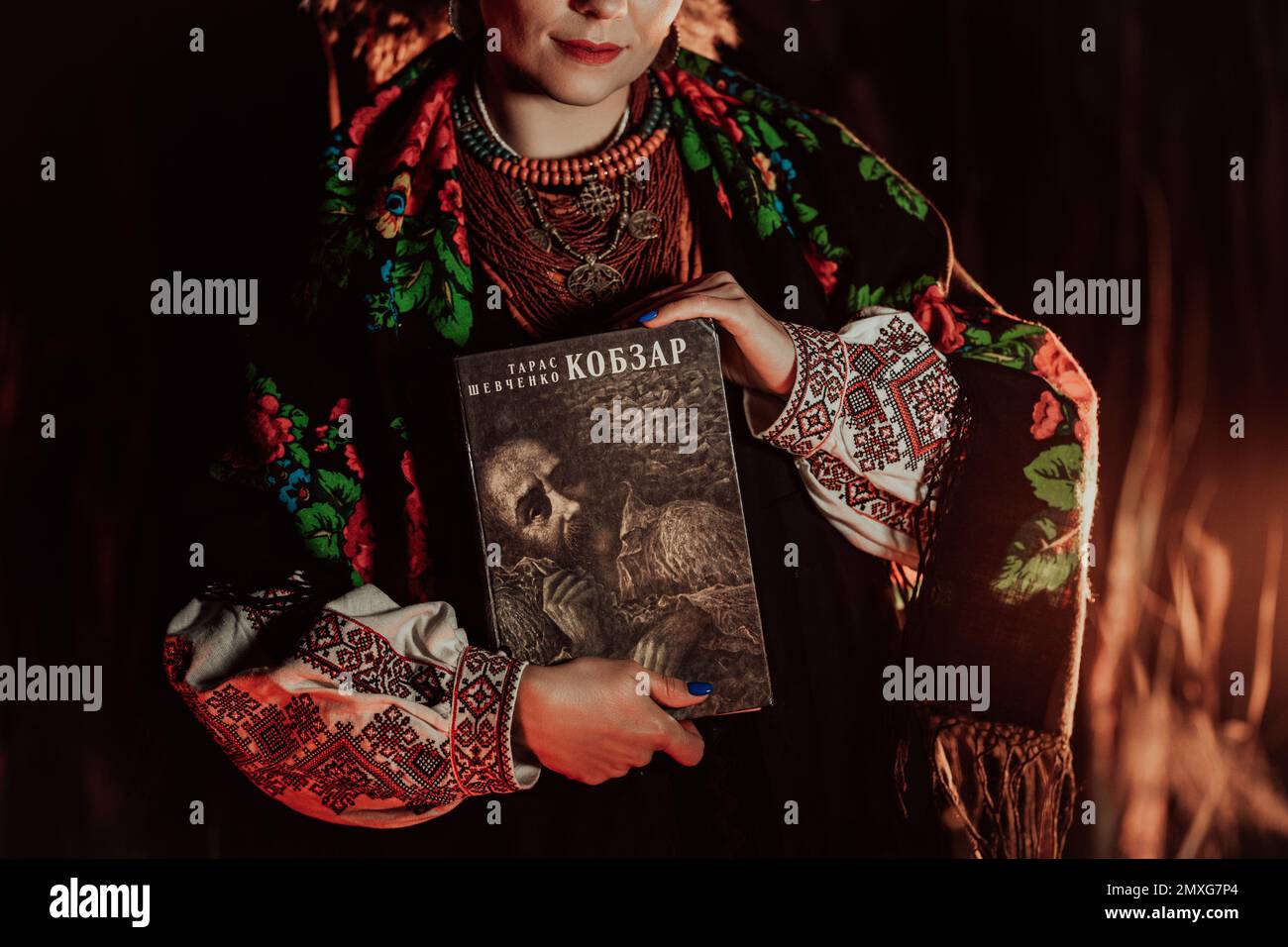 Woman holding Kobzar - poetry book collection of Taras Shevchenko - poet, bard in Ukrainian culture. Stock Photo