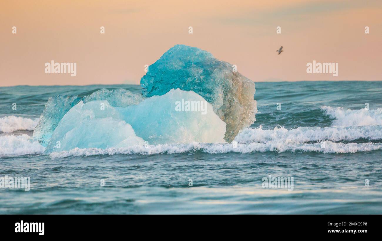 The wave crashing against a small iceberg bit floating in the sea Stock ...