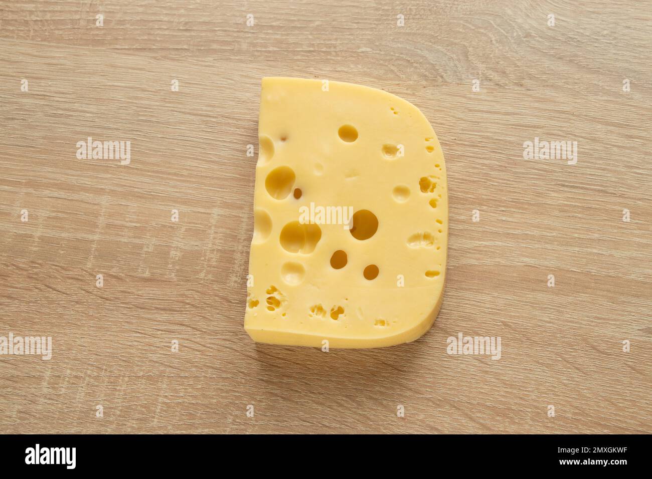 piece of cheese on a wooden background close-up Stock Photo
