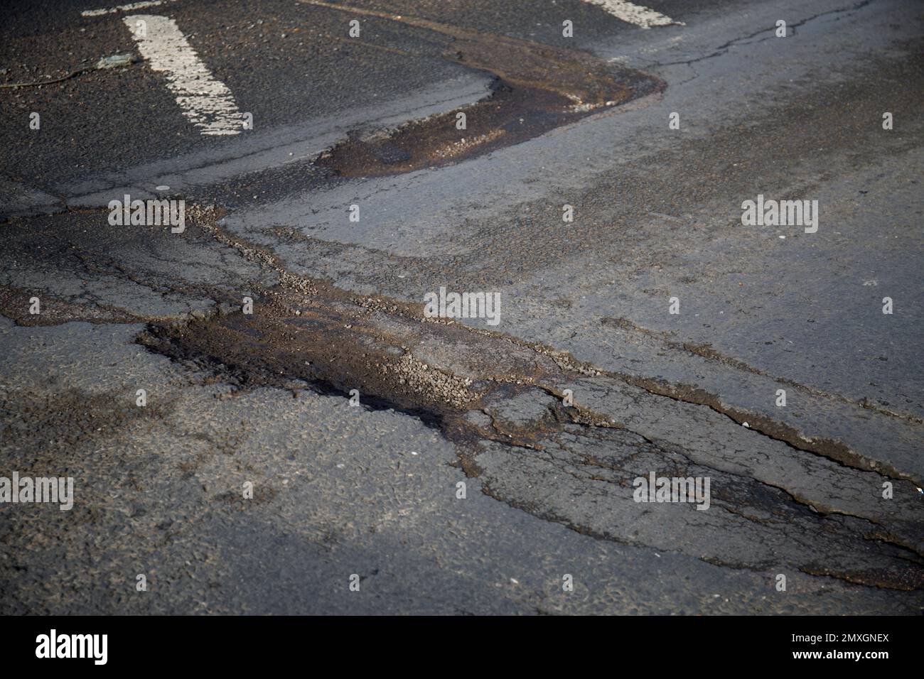 Pot Hole Potholes in Road Surface A414 Church Langley Roundabout Harlow Essex Stock Photo