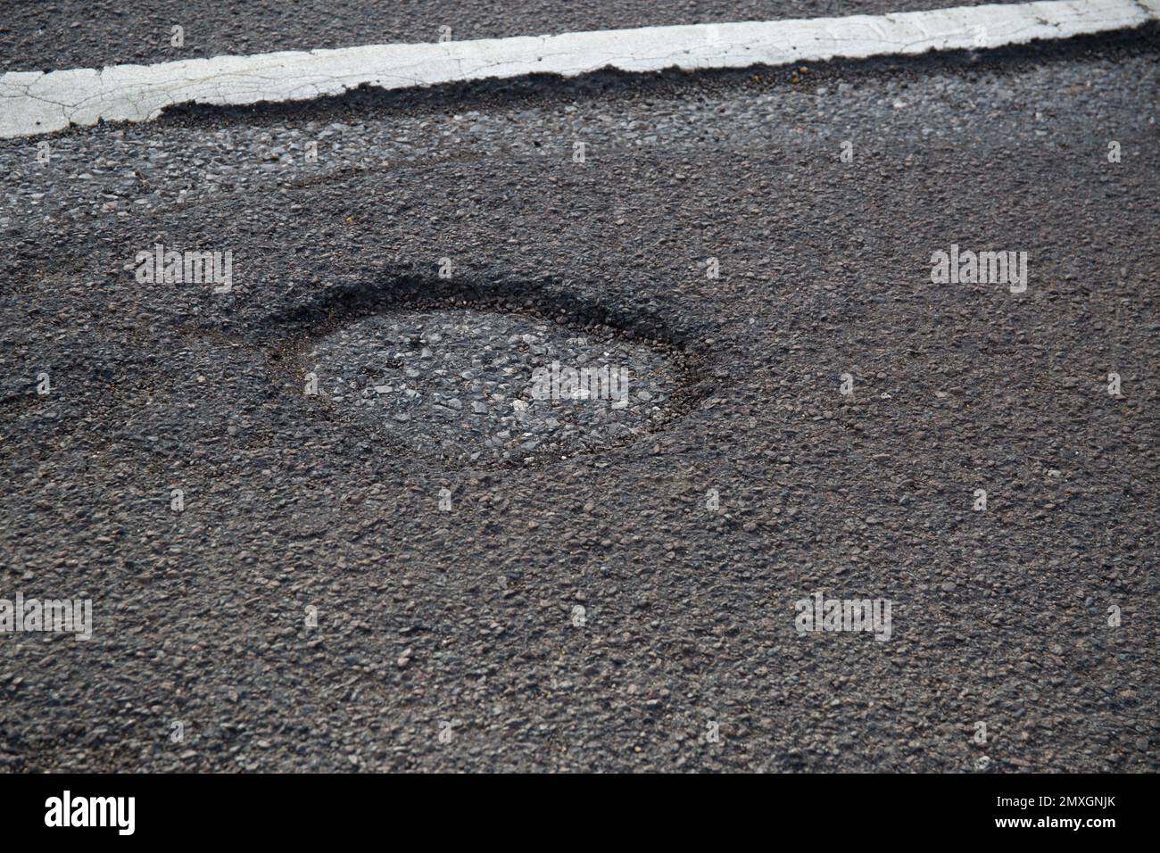 Pot Hole Pothole in Road Surface Church Langley Harlow Essex Stock Photo