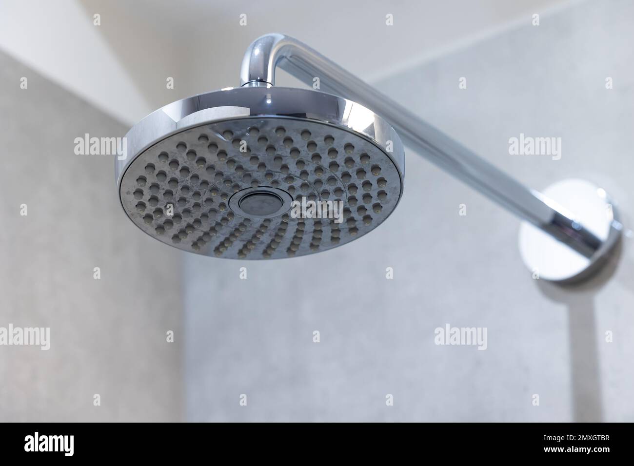 Shower head fixed to the shower tray wall. Shower with spray from above