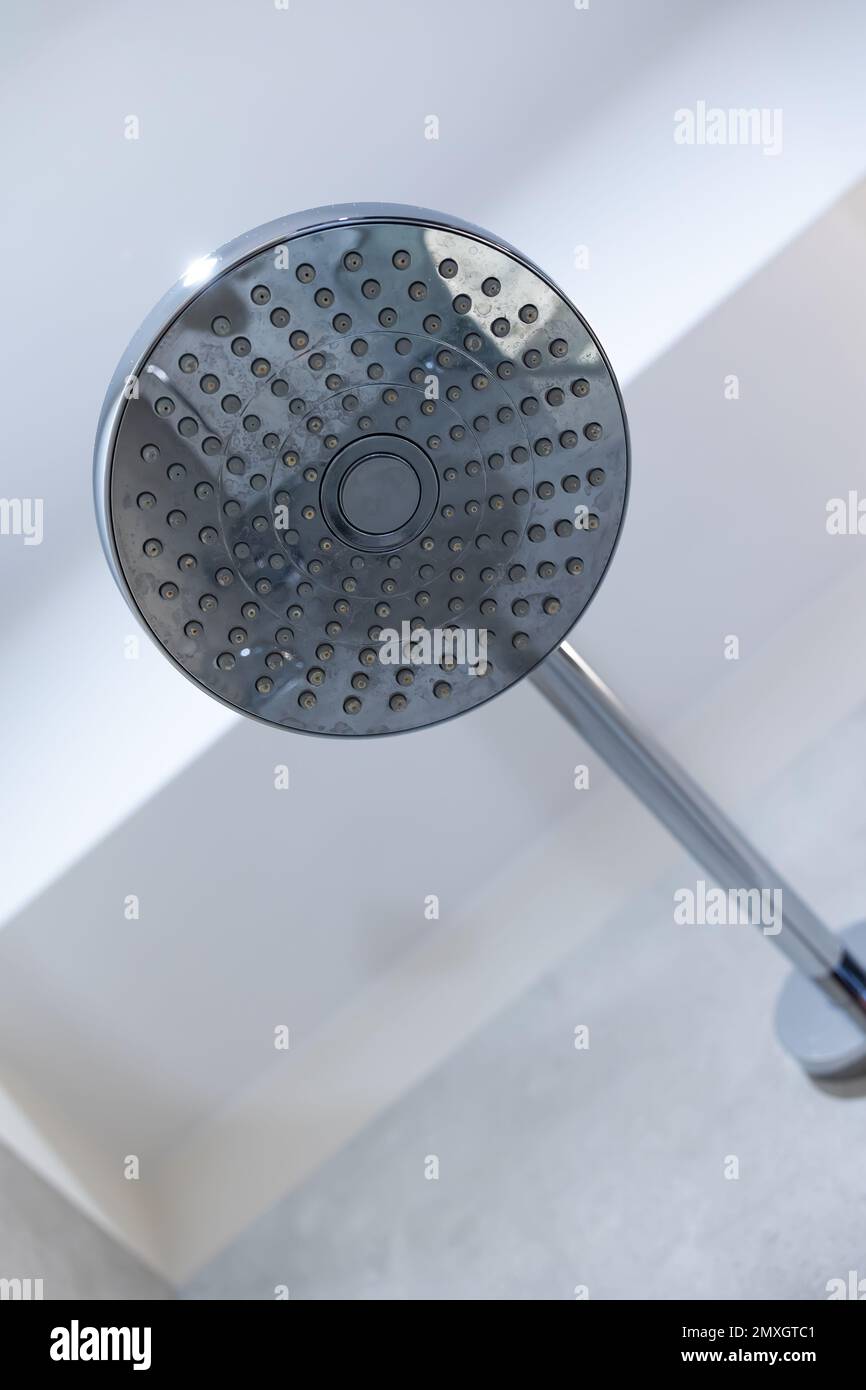 Shower head fixed to the shower tray wall. Shower with spray from above