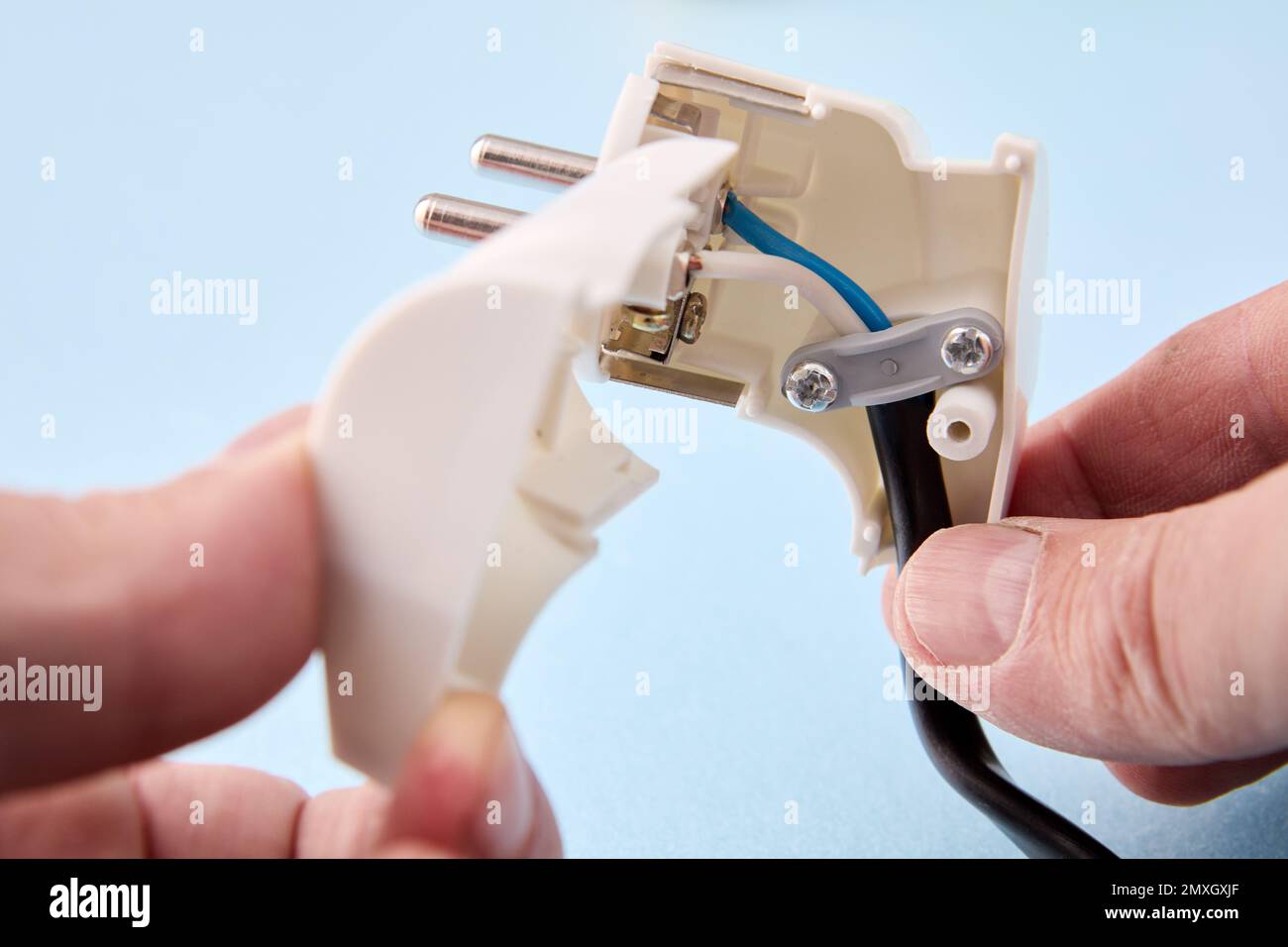 DIY installation of folding electric plug on an electric cord Stock