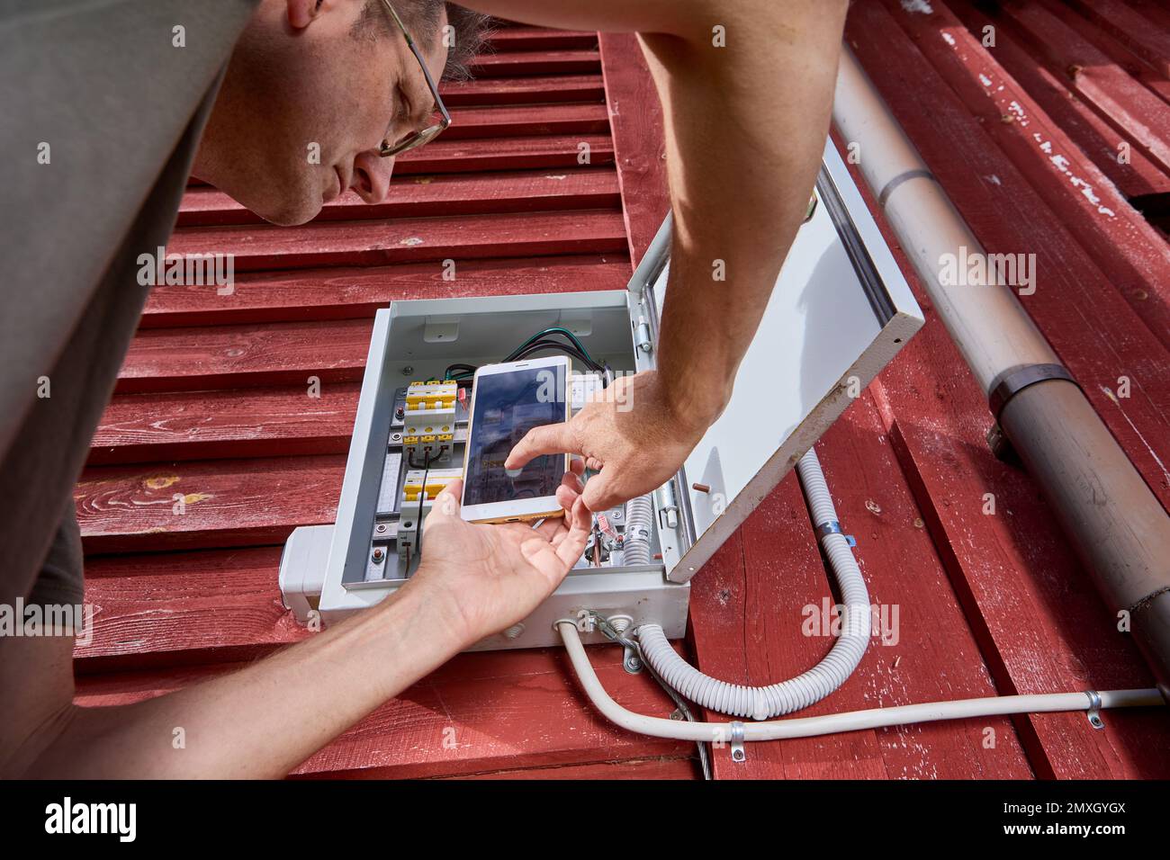 Photographing electricity meter reading with cell phone, homeowner