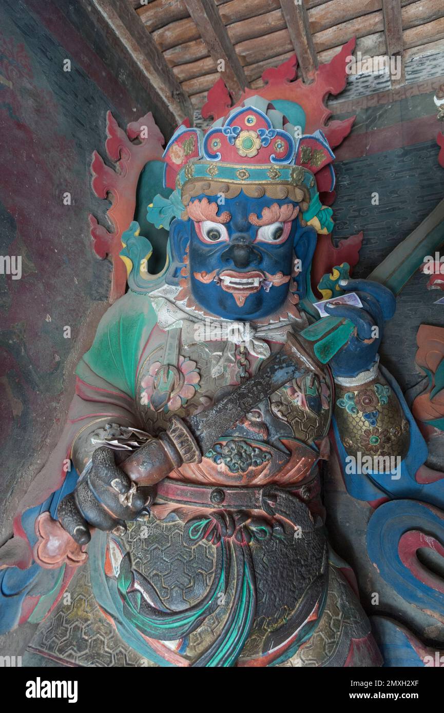 Brightly coloured statues of Tibetan deities inside the Buddhist Kumbum chorten in Gyantse in the Pelkor Chode Monastery - Tibet Stock Photo