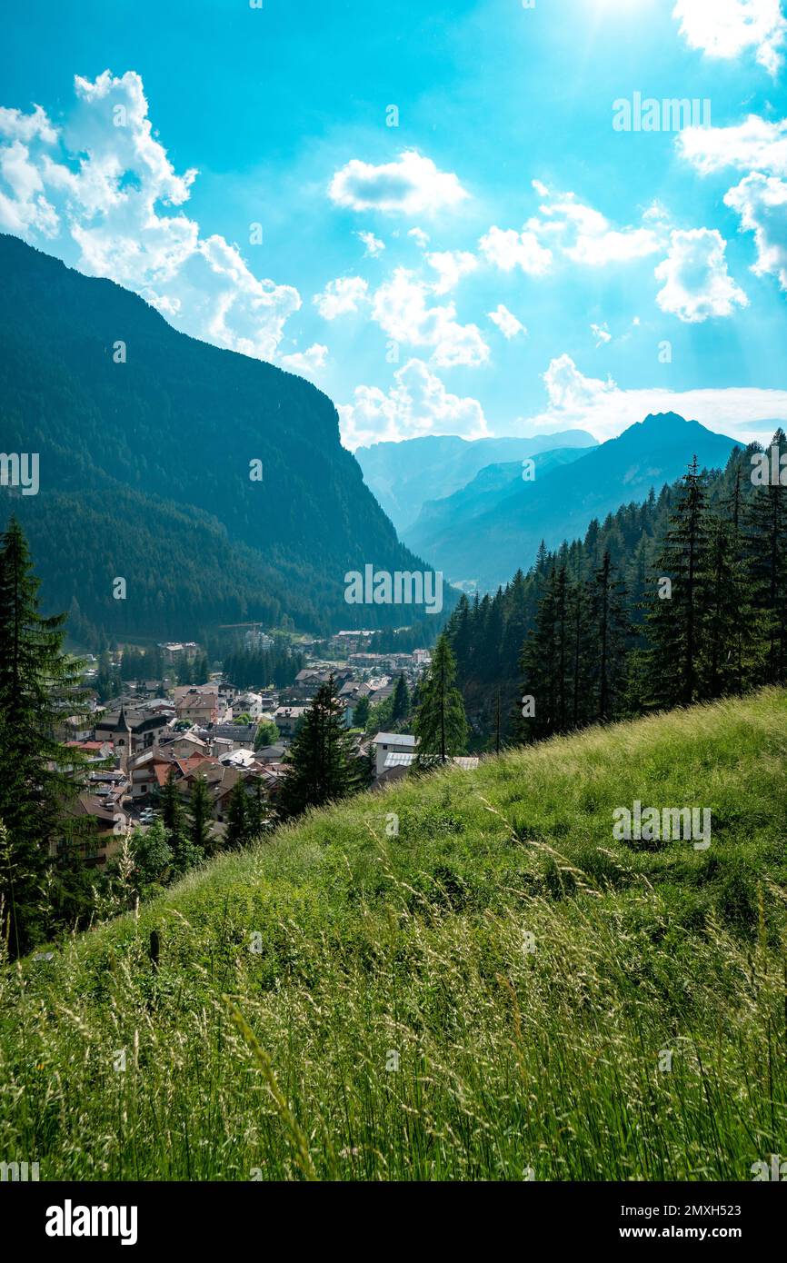 A scenic vertical view of village in lush green valley surrounded by ...