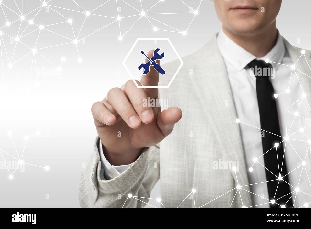 Man touching icon on virtual screen against light background, closeup. Technical support Stock Photo