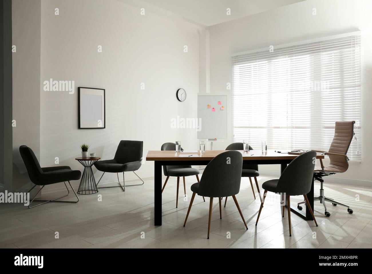 Simple office interior with large table and chairs Stock Photo - Alamy