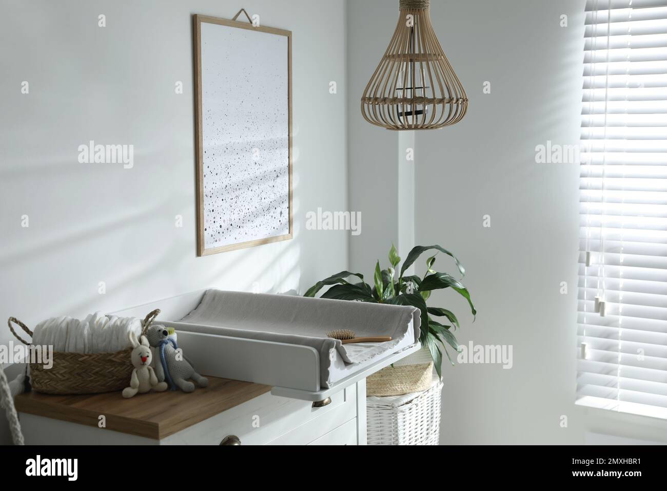 Chest of drawers with changing tray and pad in baby room. Interior