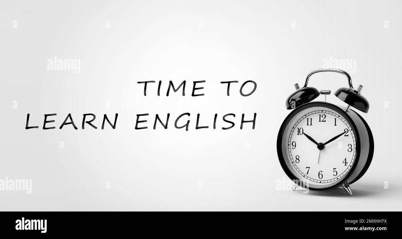 Alarm clock and phrase time to learn english on white background