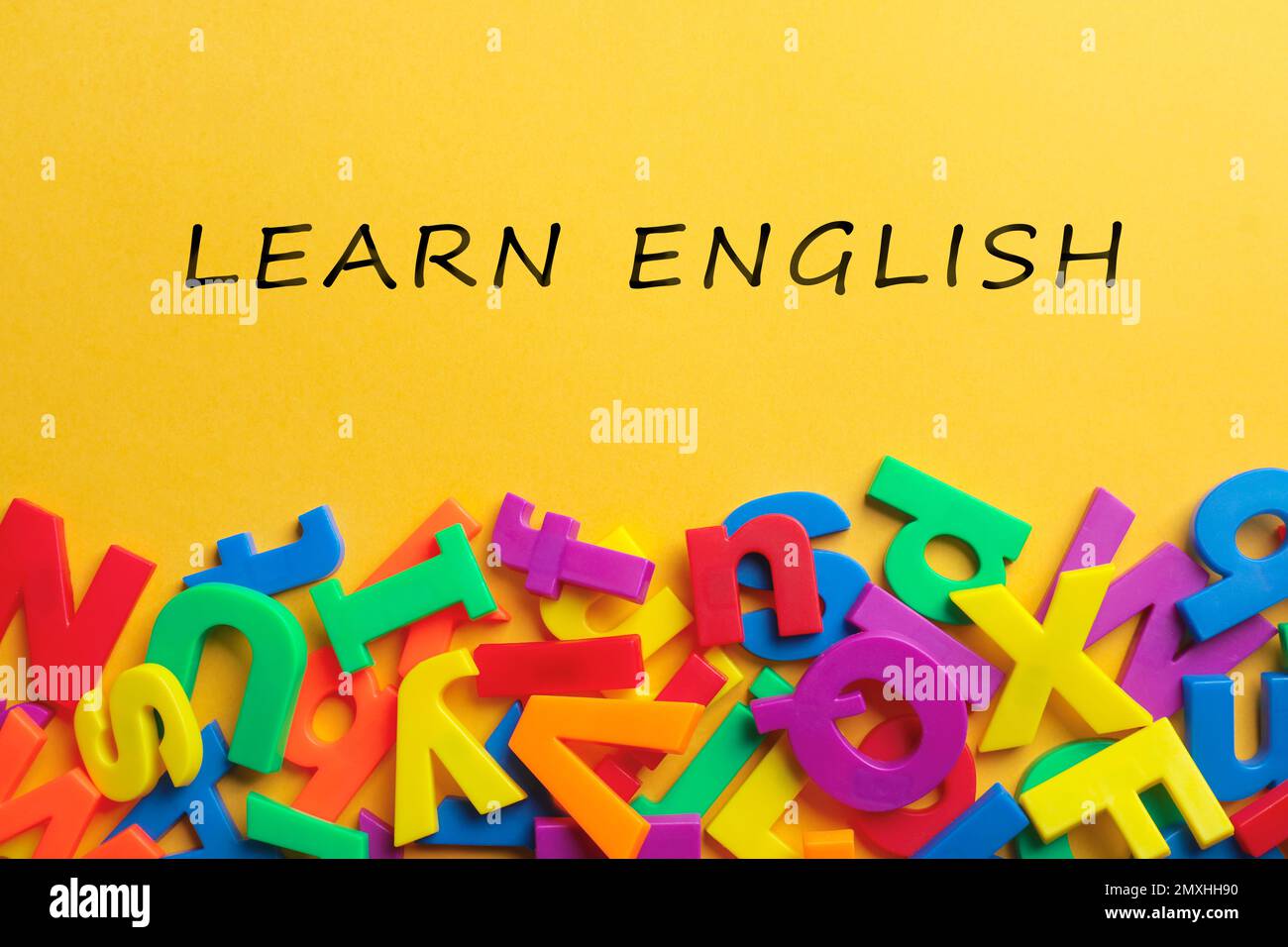 Text Learn English and plastic letters on yellow background, top view Stock Photo