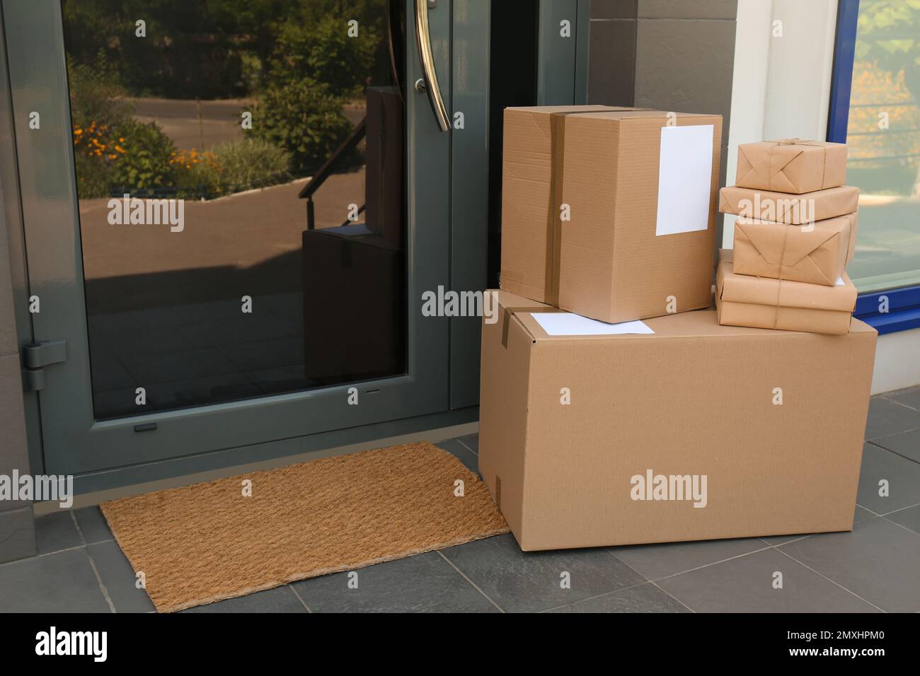 Cardboard boxes near door. Parcel delivery service Stock Photo Alamy