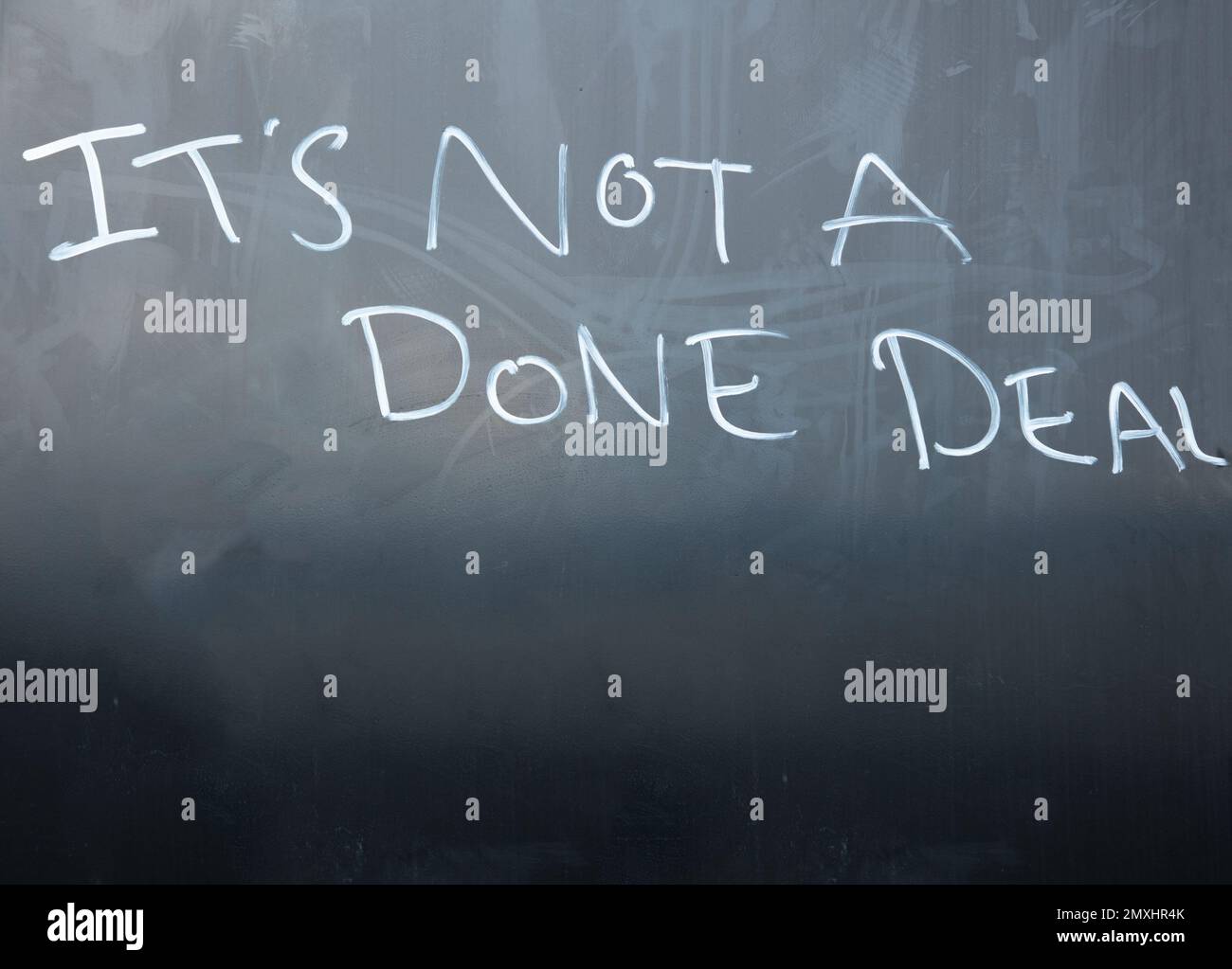 Blackboard with the words it's not a done deal written in white chalk. Stock Photo