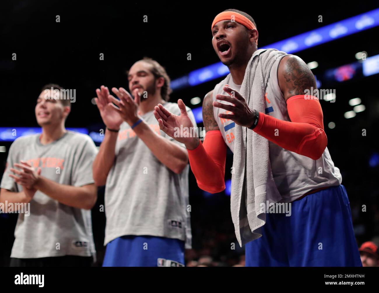 New York Knicks forward Carmelo Anthony, right, cheers on teammates