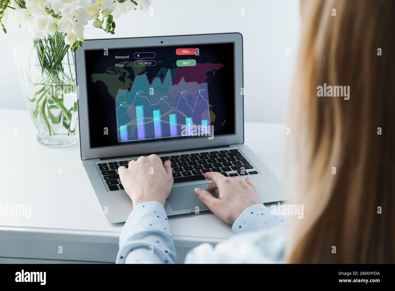 Broker working with laptop at table, closeup. Forex trading Stock Photo