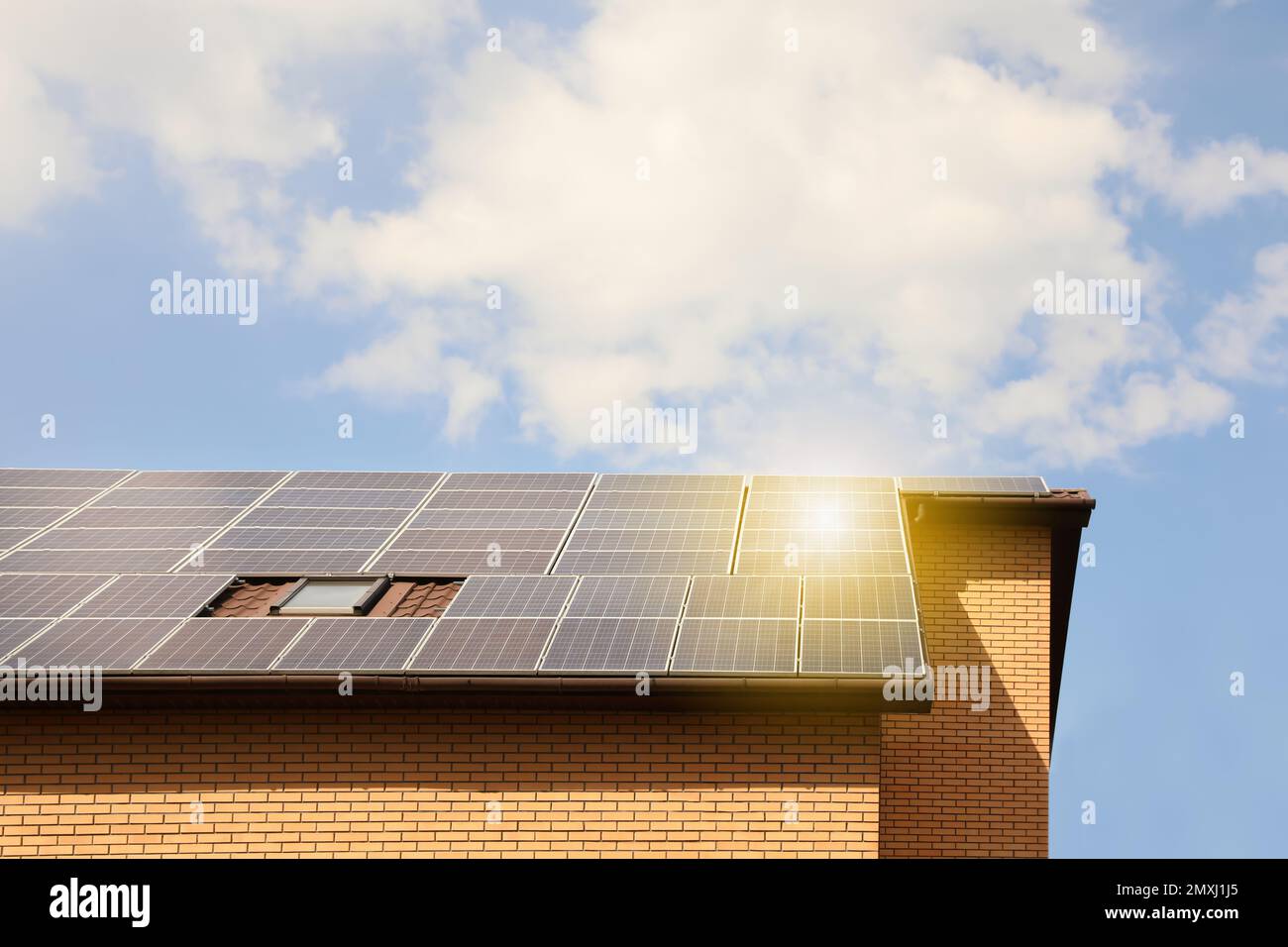 Building with installed solar panels on roof. Alternative energy source