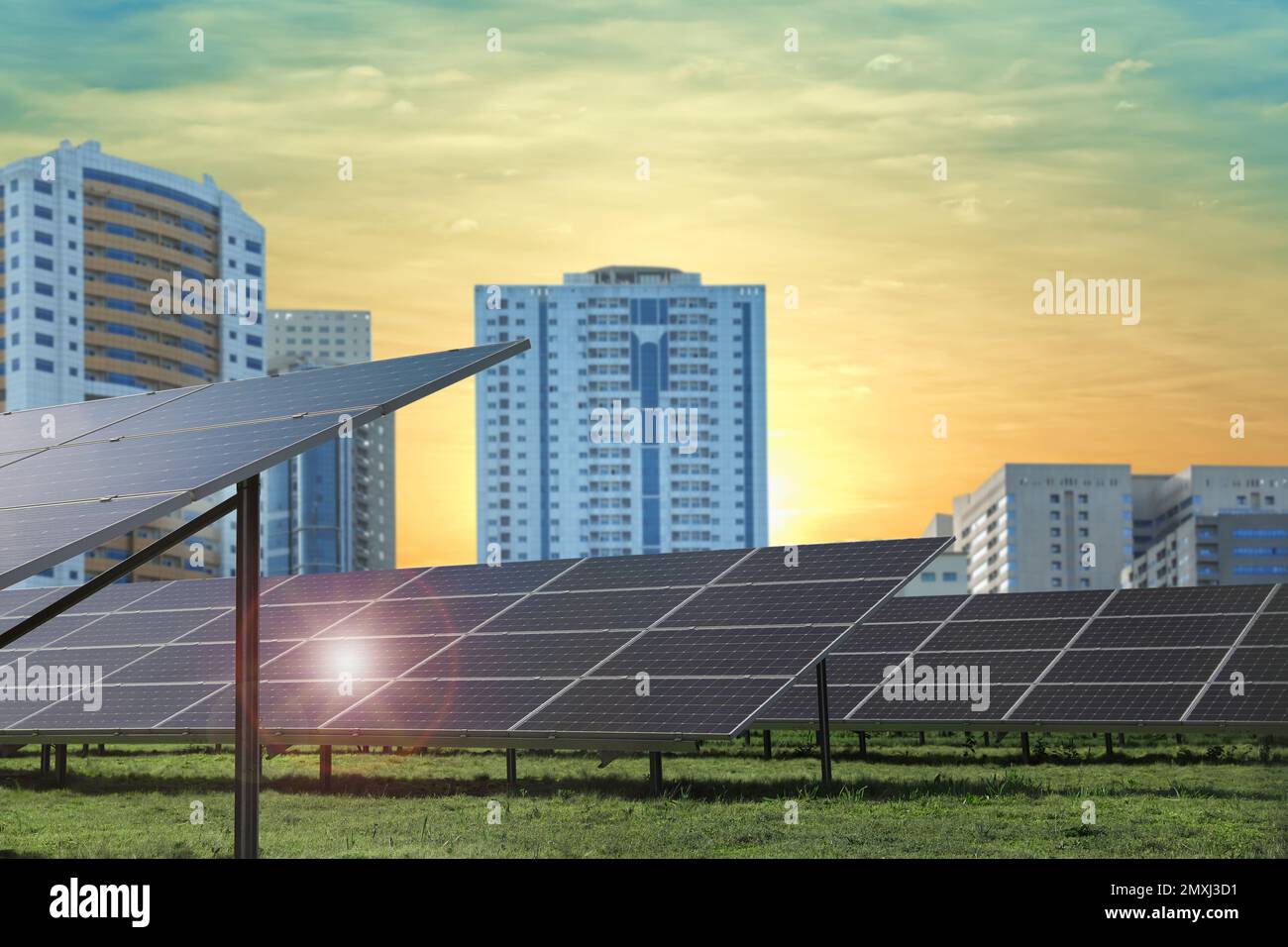 Cityscape and solar panels installed outdoors. Alternative energy ...