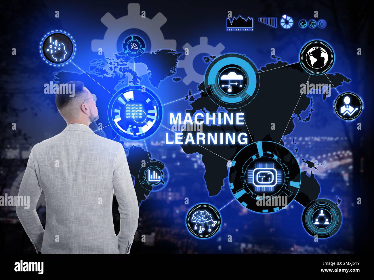 Young businessman near virtual screen with machine learning model and night cityscape on background Stock Photo