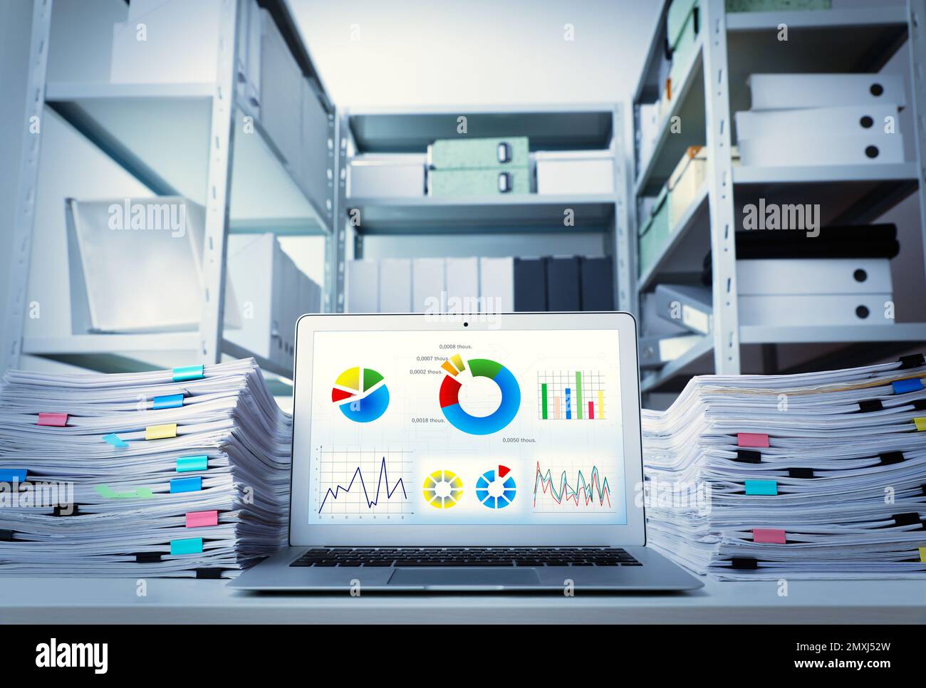 Modern laptop and documents on desk in office. Business analytics Stock Photo