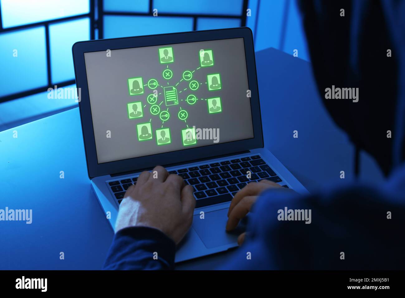Hacker cracking access to documents using laptop Stock Photo - Alamy