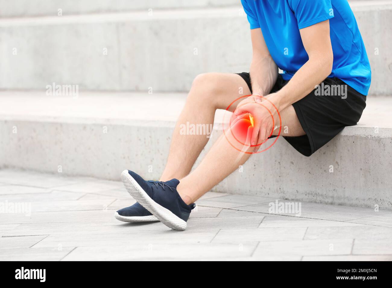 Man suffering from knee pain on stairs, closeup Stock Photo Alamy