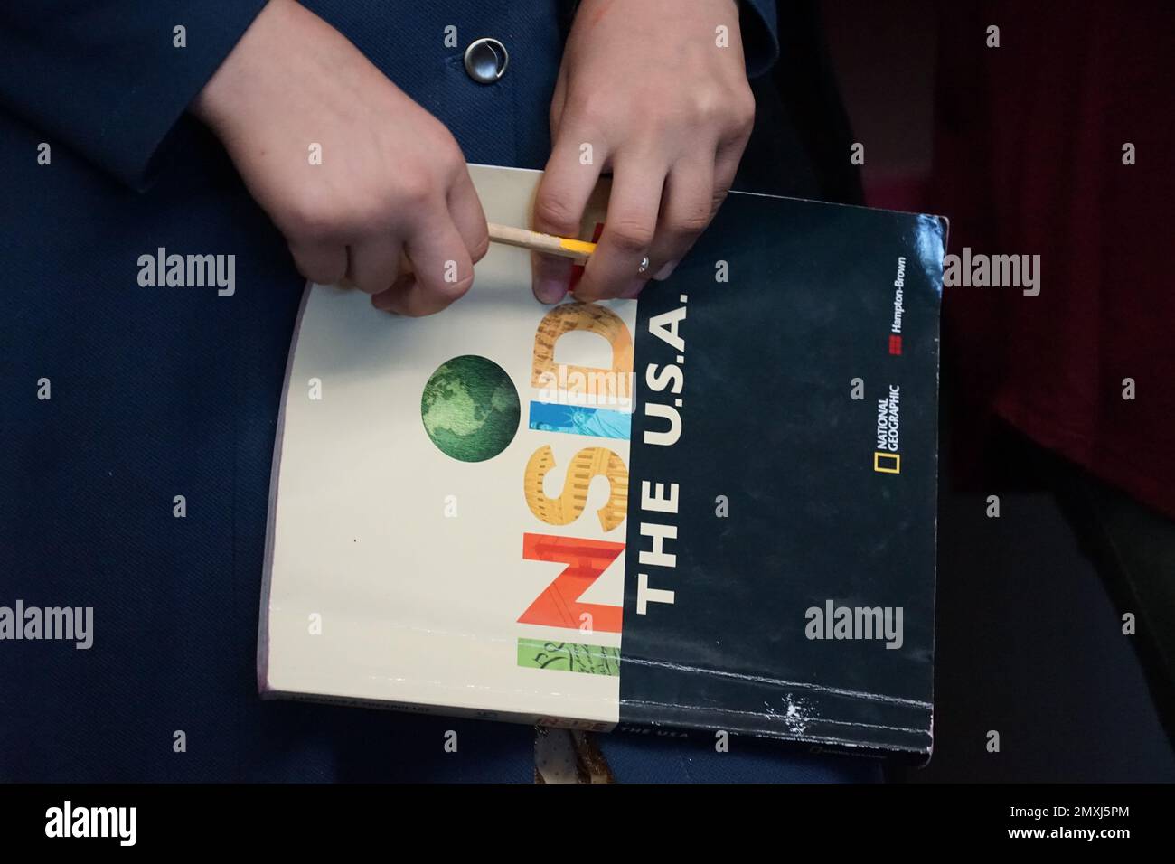 In this Tuesday, Oct. 4, 2016 photo, a student holds an "Inside the USA