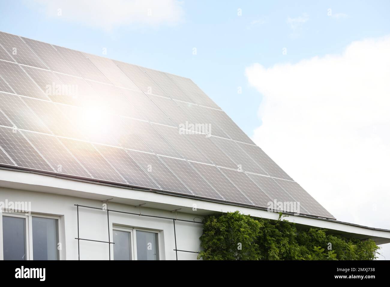 Building with installed solar panels on roof. Alternative energy source