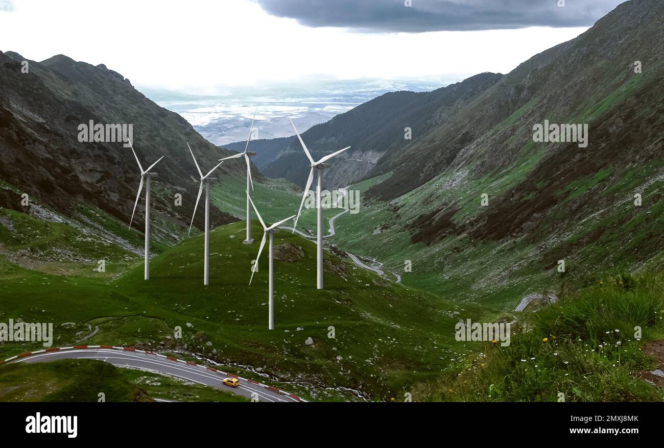 Alternative energy source. Wind turbines and mountains outdoors Stock Photo