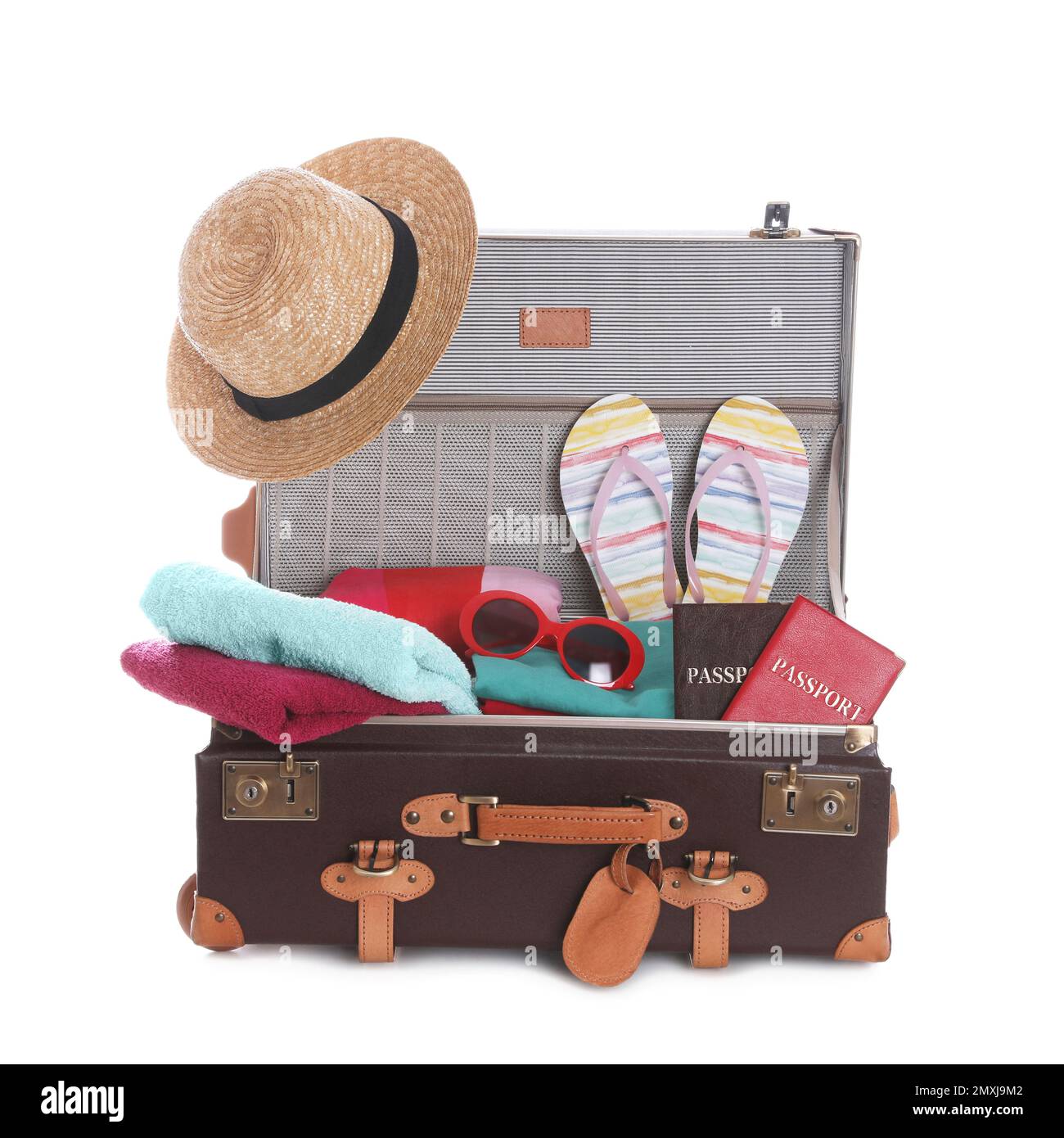 Open vintage suitcase with clothes packed for summer vacation isolated ...