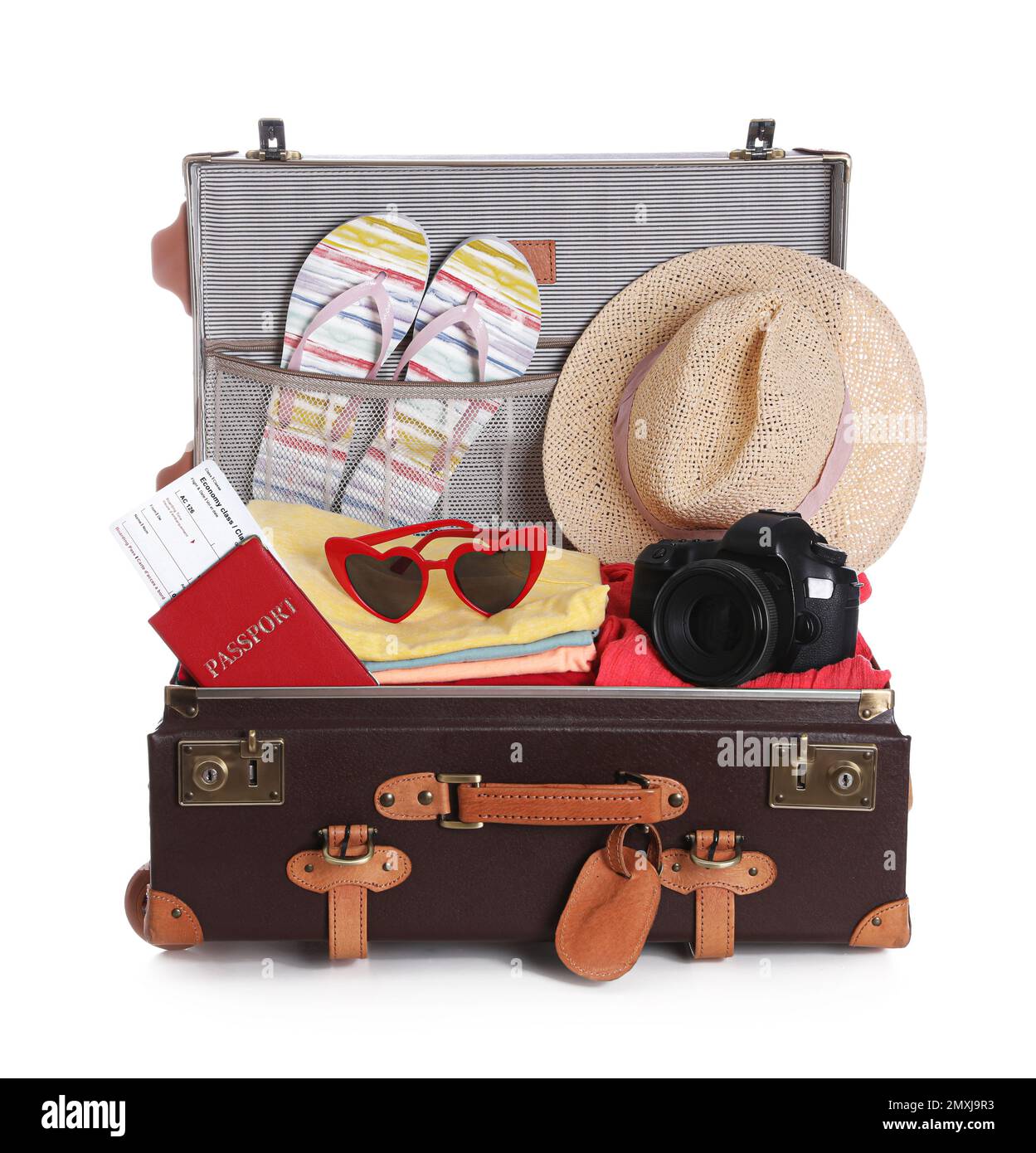 Open vintage suitcase with clothes packed for summer vacation isolated ...