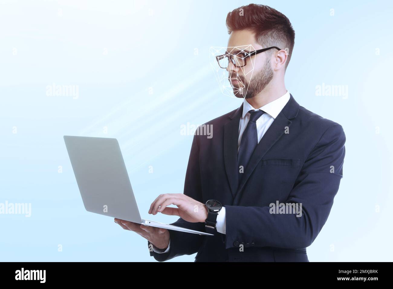 Facial recognition system. Man using laptop on light blue background Stock Photo