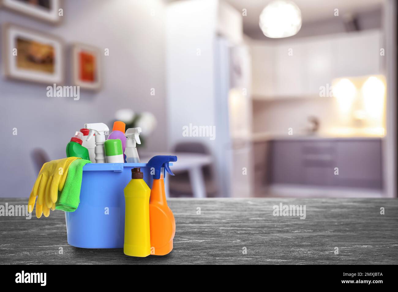 https://c8.alamy.com/comp/2MXJBTA/bucket-with-cleaning-supplies-on-stone-surface-in-modern-room-space-for-text-2MXJBTA.jpg