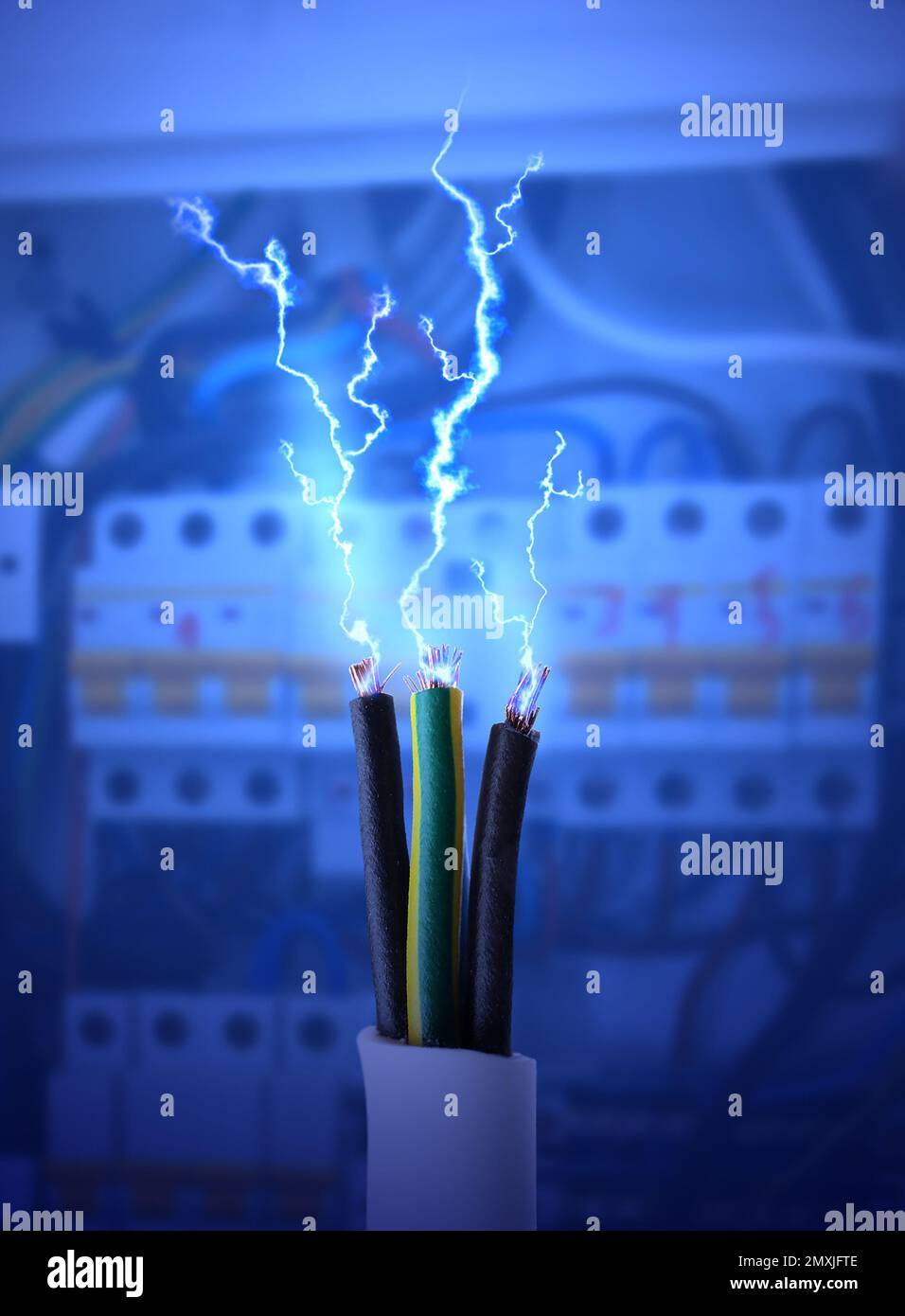 Sparking cables against blurred electric cabinet, closeup Stock Photo