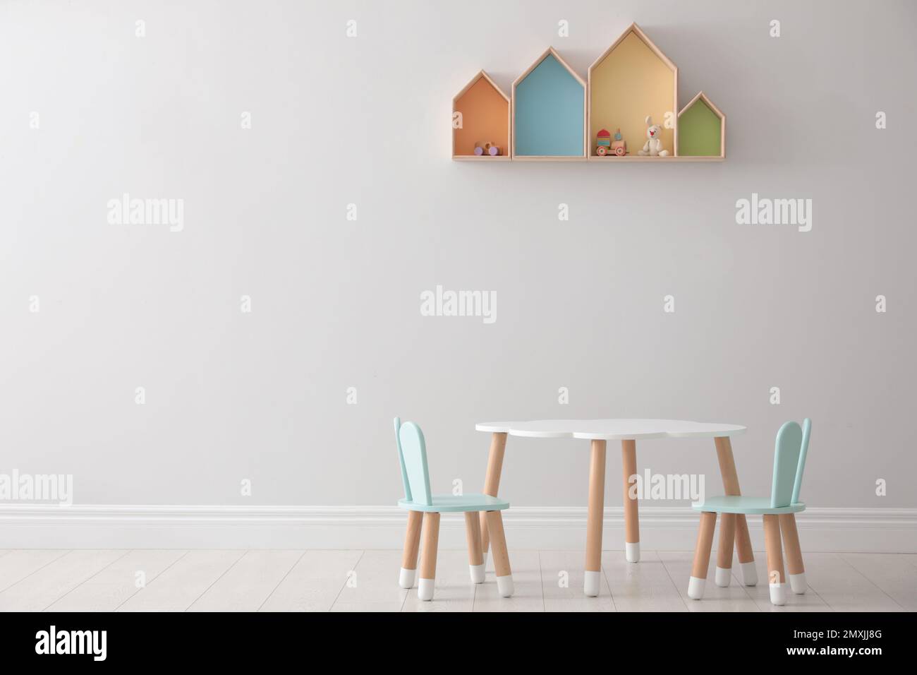 House shaped shelves and little table with chairs in children's room ...