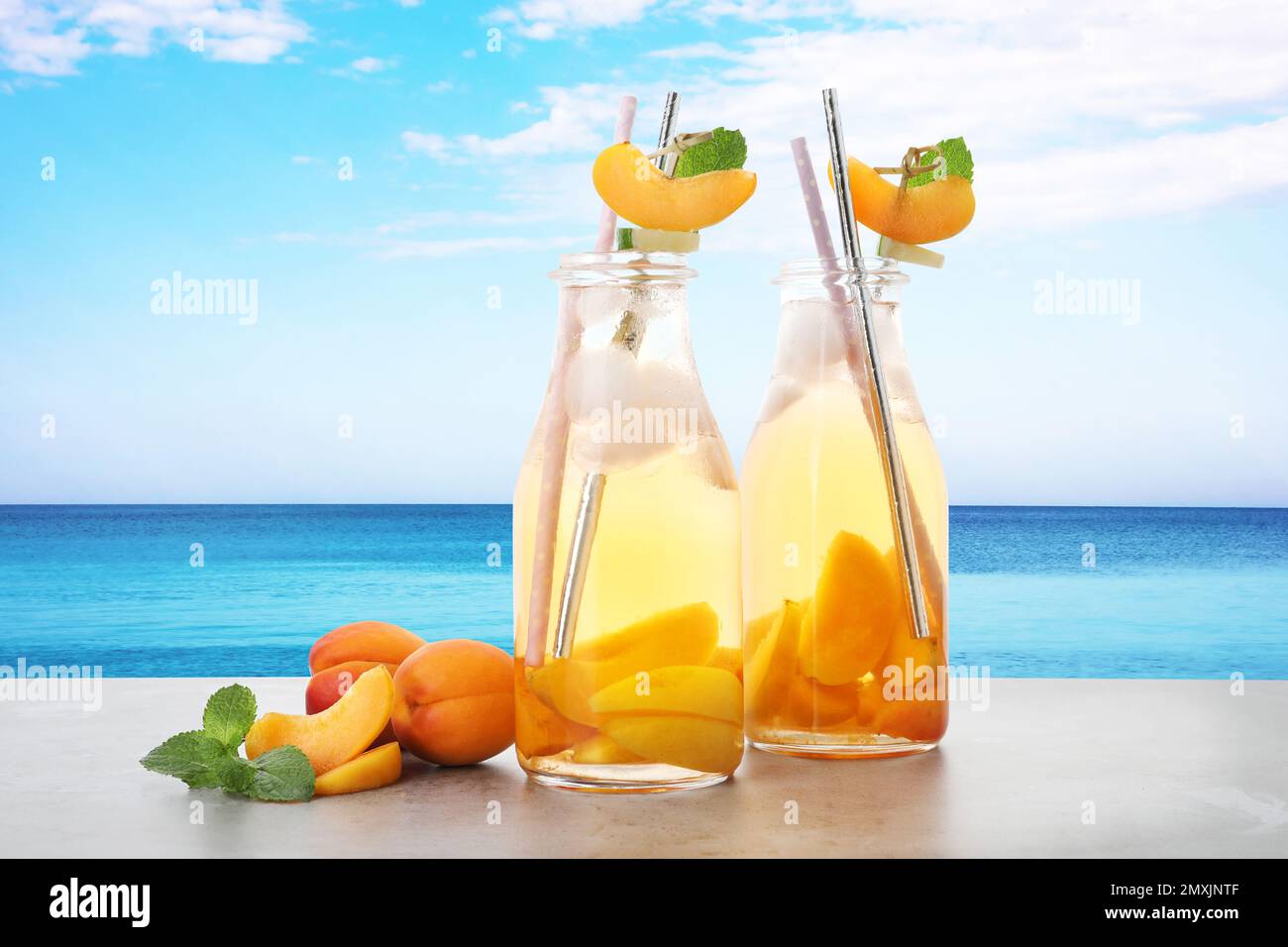 Tasty refreshing drink on table against sea Stock Photo