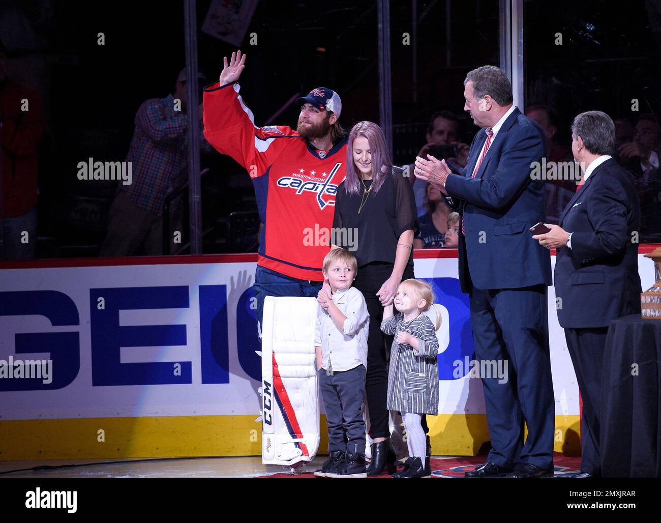 Washington Capitals goalie Braden Holtby, left, waves at the crowd as he  was honored for his Vezina Trophy season, before the Capitals' NHL hockey  game against the Colorado Avalanche, Tuesday, Oct. 18,