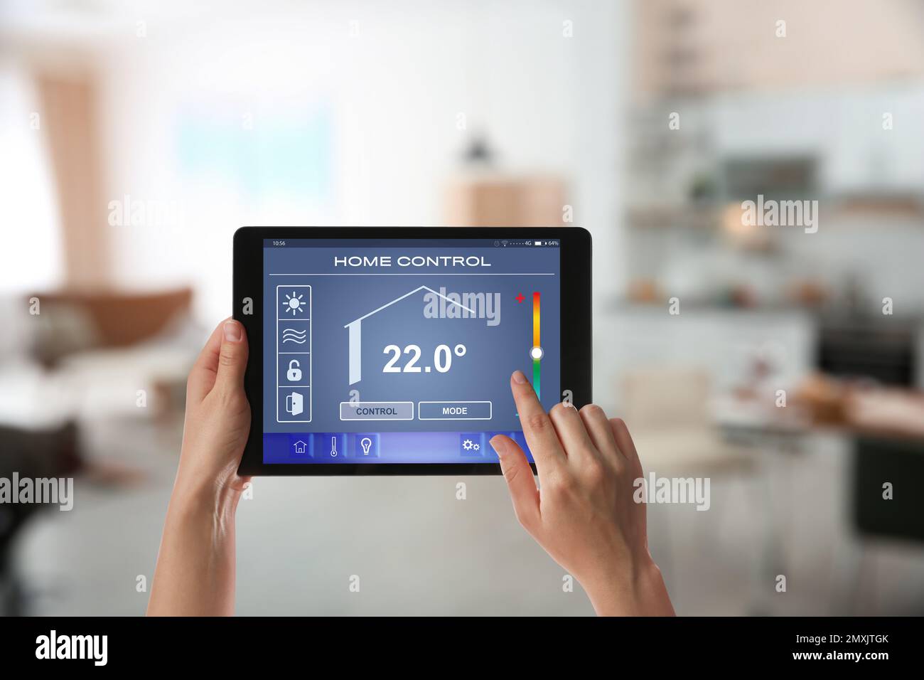 Woman using tablet to set indoor temperature, closeup. Smart home ...