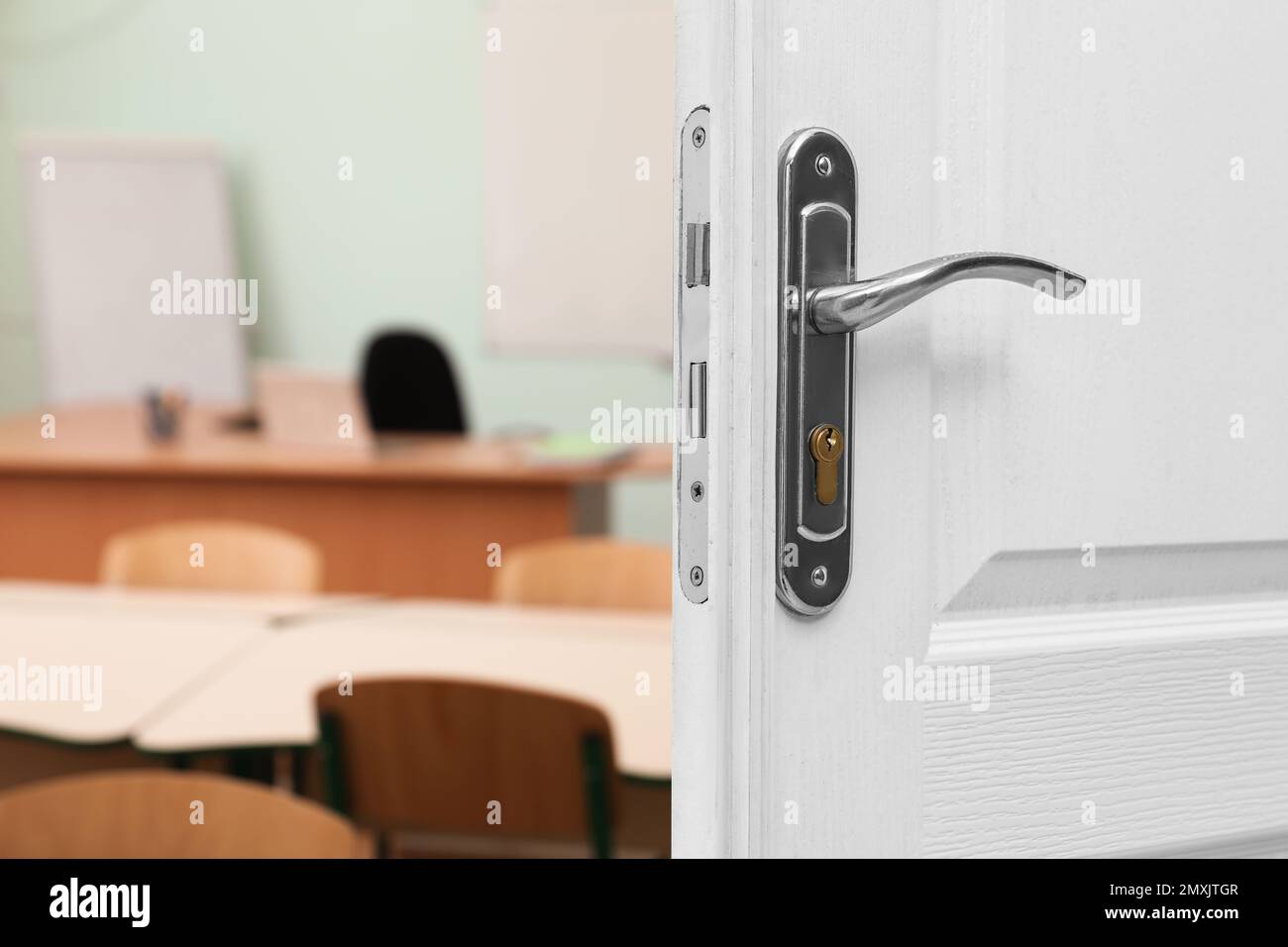 Wooden door open into modern empty classroom Stock Photo