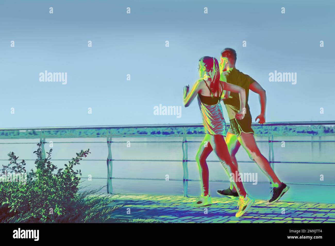 People running outdoors, view through thermal camera. Temperature detection - Covid spreading prevention measure Stock Photo