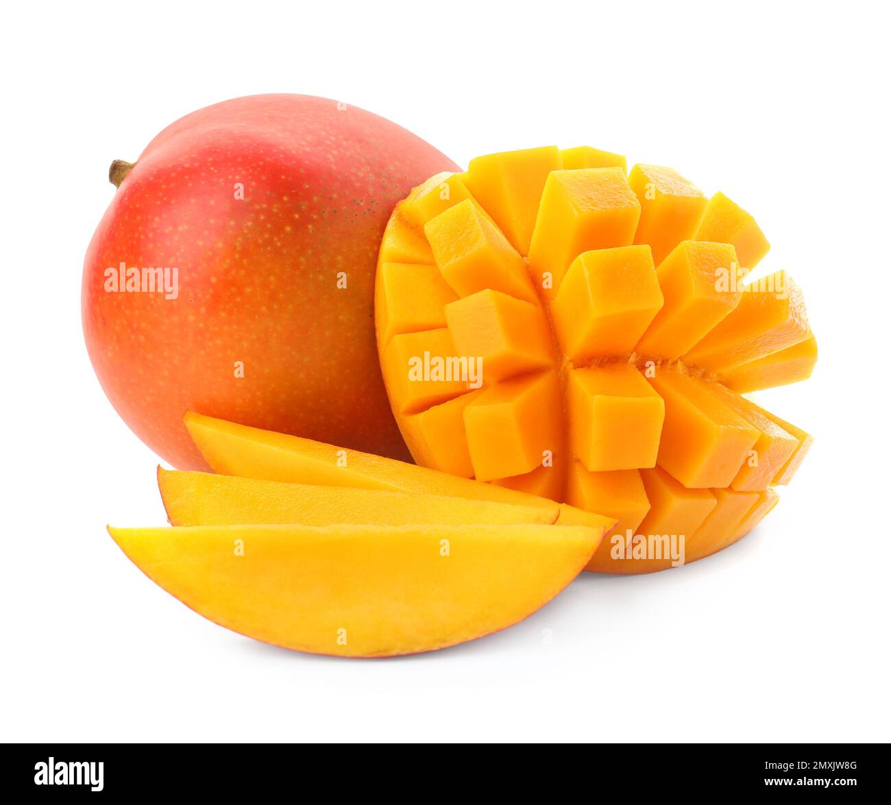 Whole and cut ripe mangoes isolated on white. Exotic fruit Stock Photo