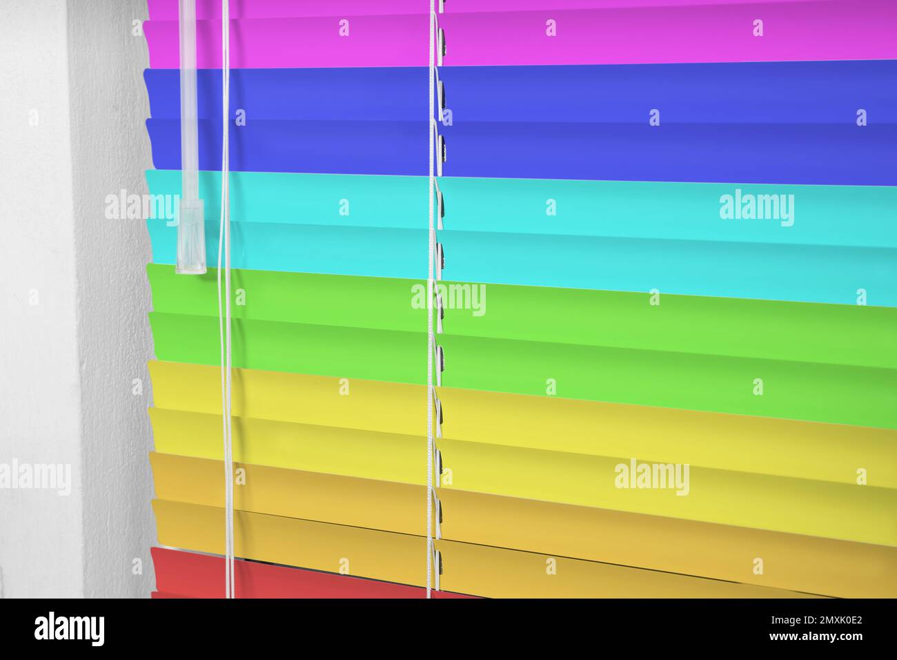 Window with closed multicolor blinds, closeup view Stock Photo