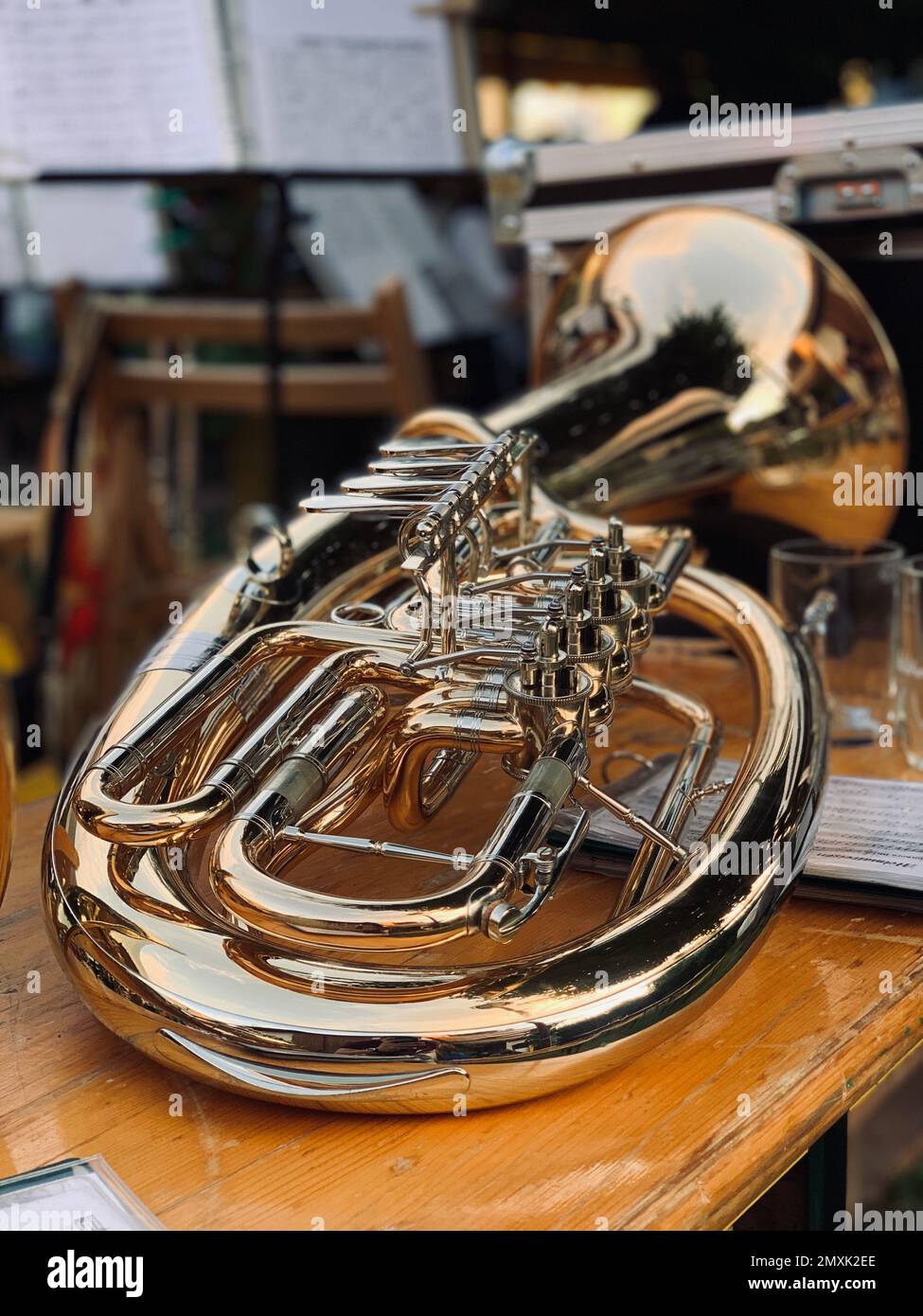 a beautiful tuba instrument lying on a beer bench after a blasmusik