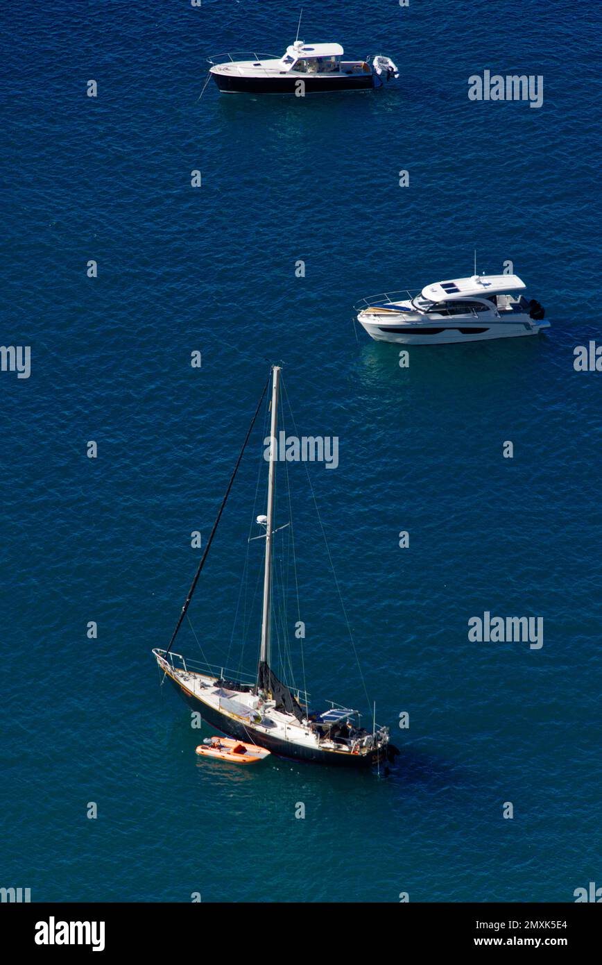 Three sail boats docking on blue water Stock Photo Alamy