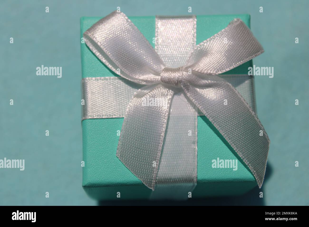 Closeup of sea foam green gift box with white bow Stock Photo