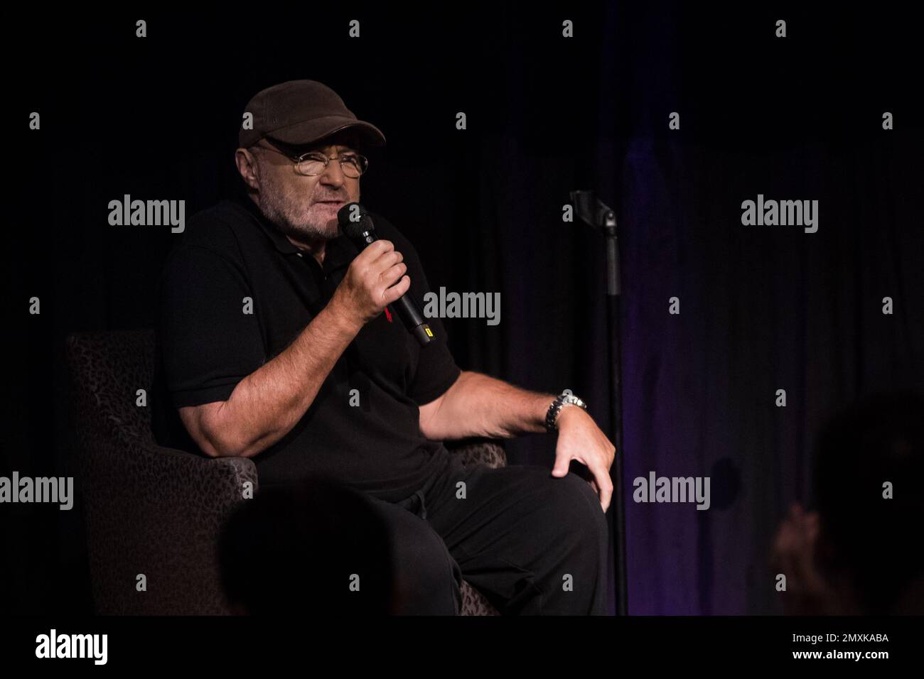 Phil Collins is interviewed by Jools Holland during a press conference