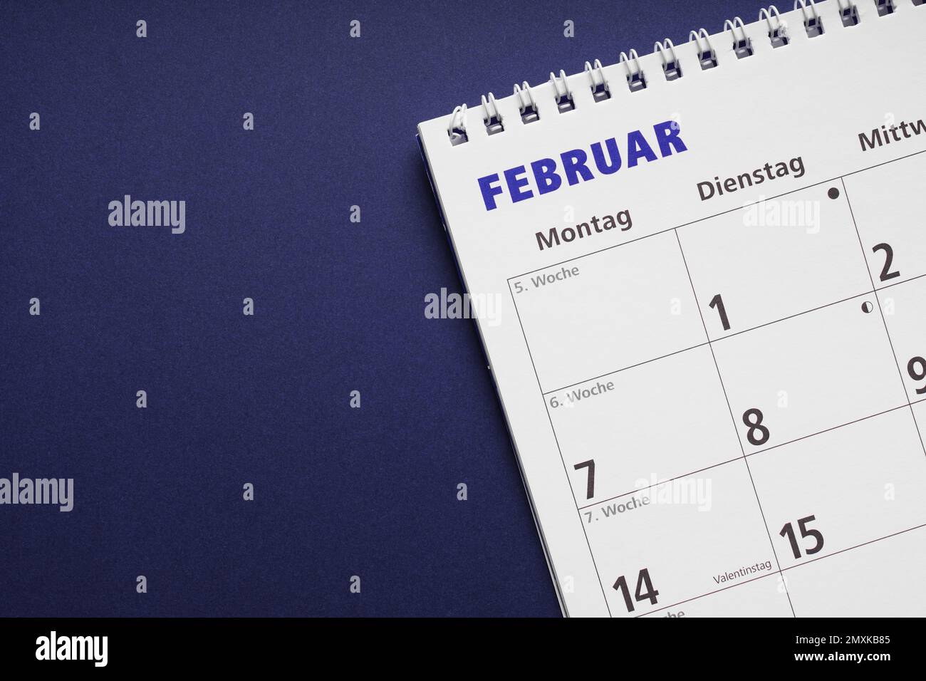 german calendar or planner for the month february on blue paper background with copy space Stock Photo