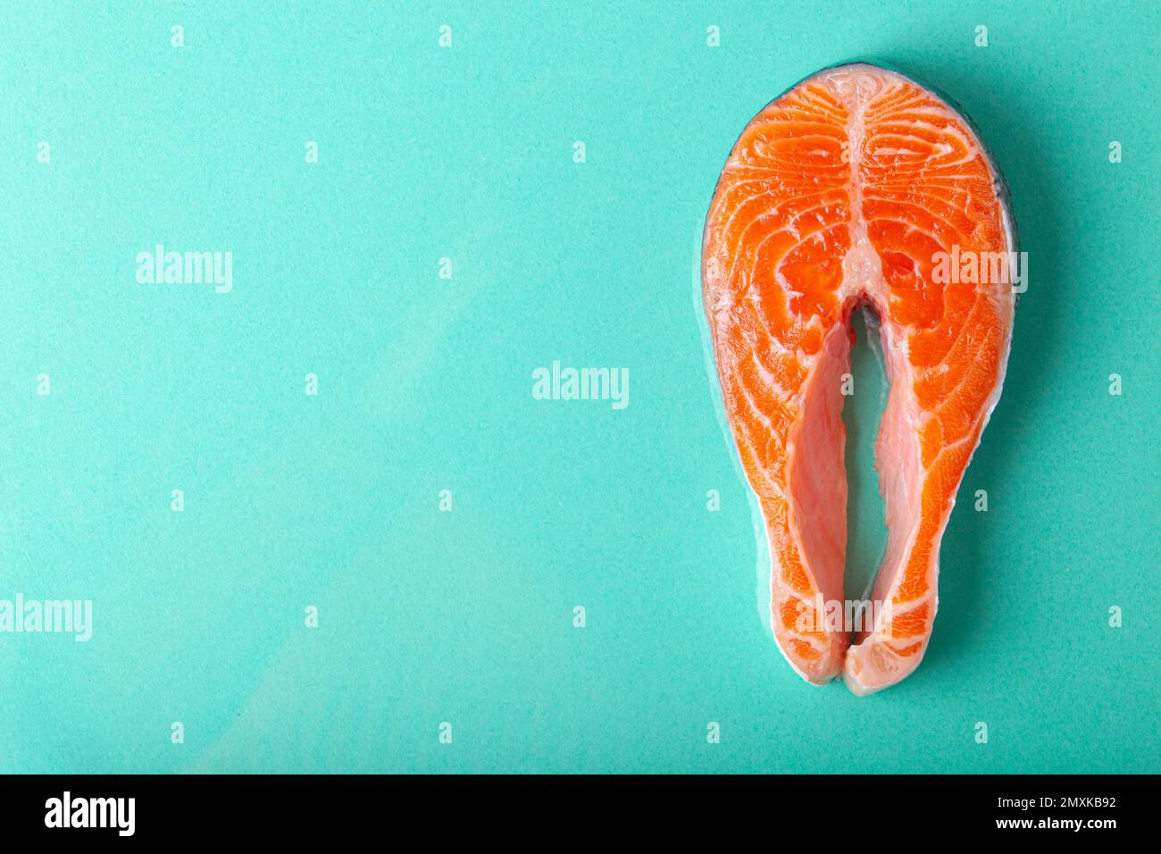 Uncooked raw fresh fish salmon steak top view on blue clean background from above, delicacy healthy fish eating and nutrition concept flat lay space f Stock Photo