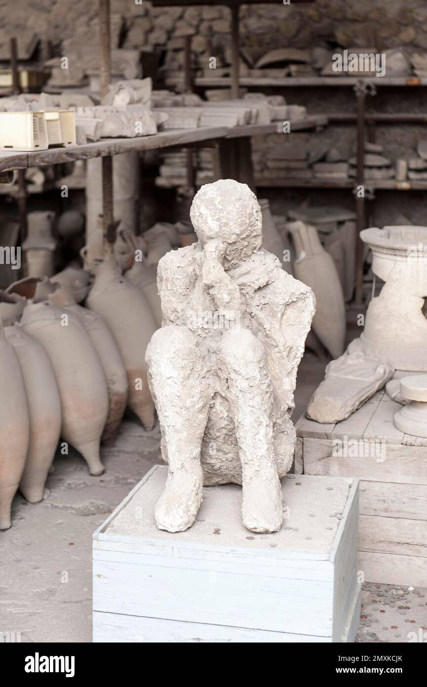 Archaeology, plaster cast of a squatting man in front of amphorae, ancient Roman city of Pompeii, Pompei, near Naples, Campania, Italy, Europe Stock Photo