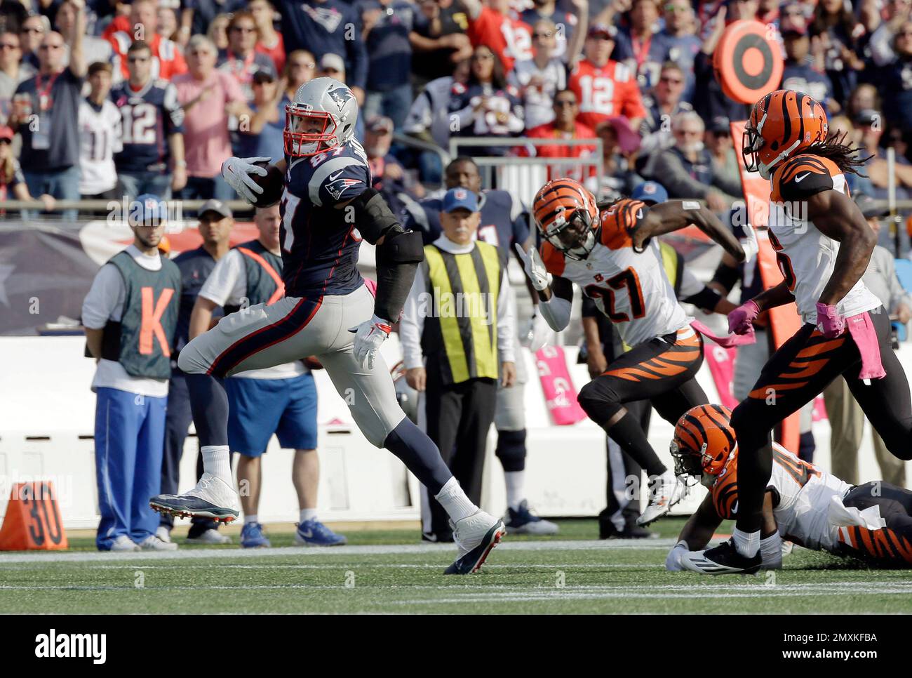 New England Patriots tight end Rob Gronkowski (87) runs from Cincinnati  Bengals defenders after catching a pass during the second half of an NFL  football game, Sunday, Oct. 16, 2016, in Foxborough,